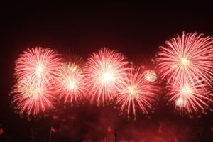 Dazzling red fireworks create a spectacular display, lighting up the night sky and celebrating festive occasions.